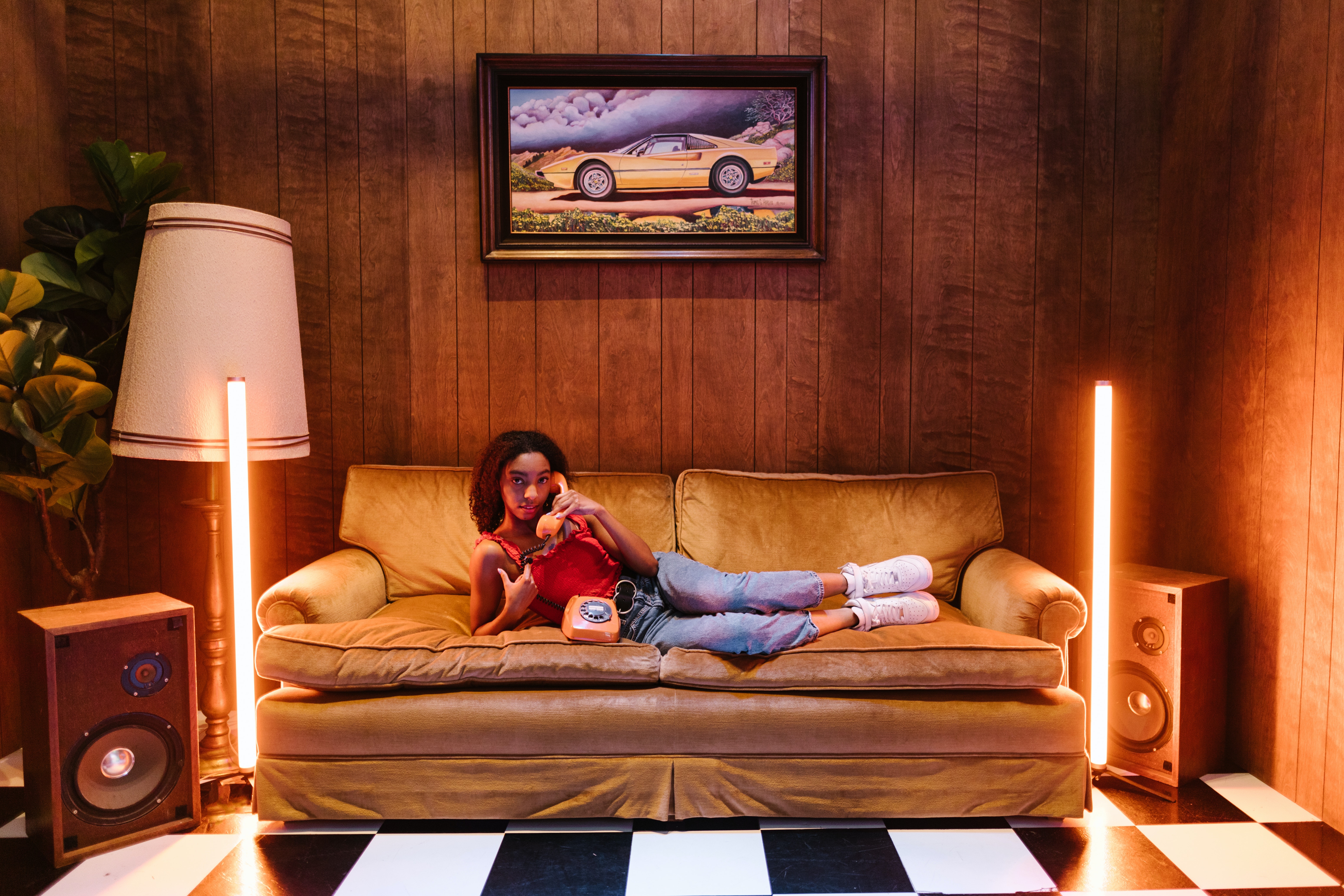 girl sitting on a couch with a phone